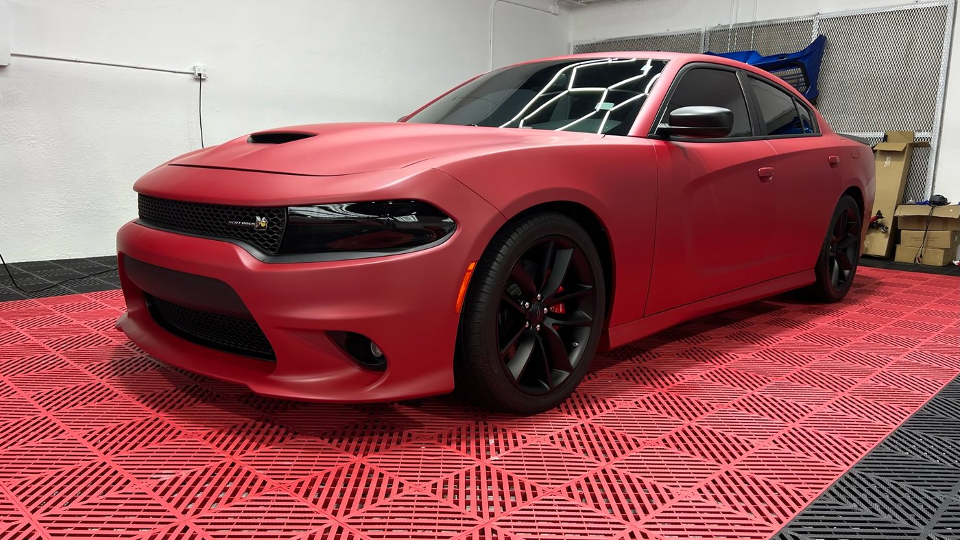 Dodge Charger SRT wrapped in satin red at Elite Premium Detailing in Davie
