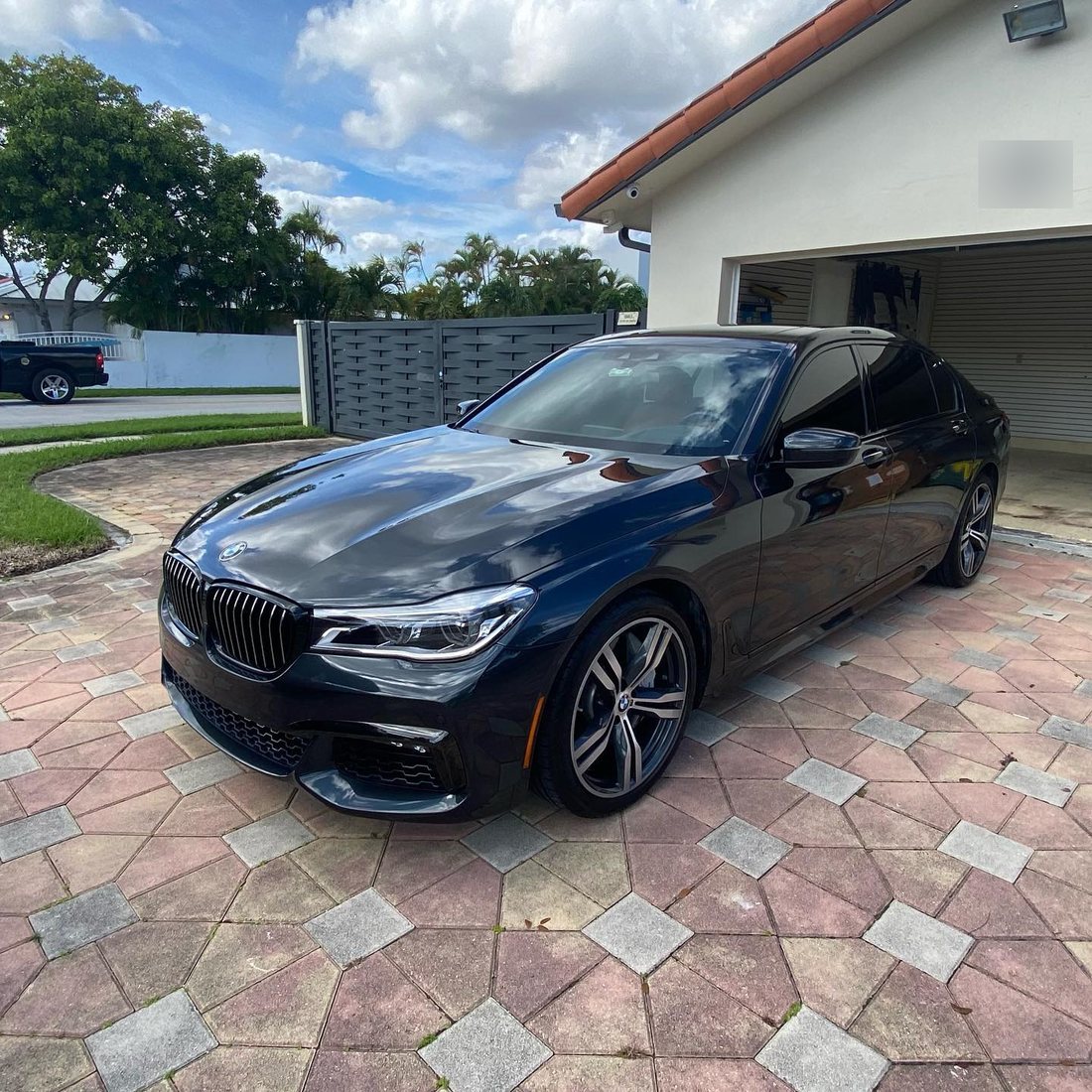 BMW 750 ceramic coated by Elite at a client's home driveway in Miami, 2020