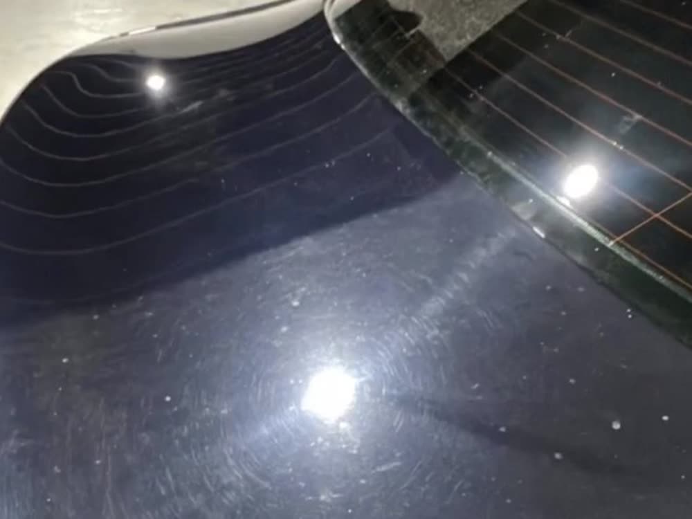Paint correction on black paint &mdash; swirl marks removed, mirror finish restored